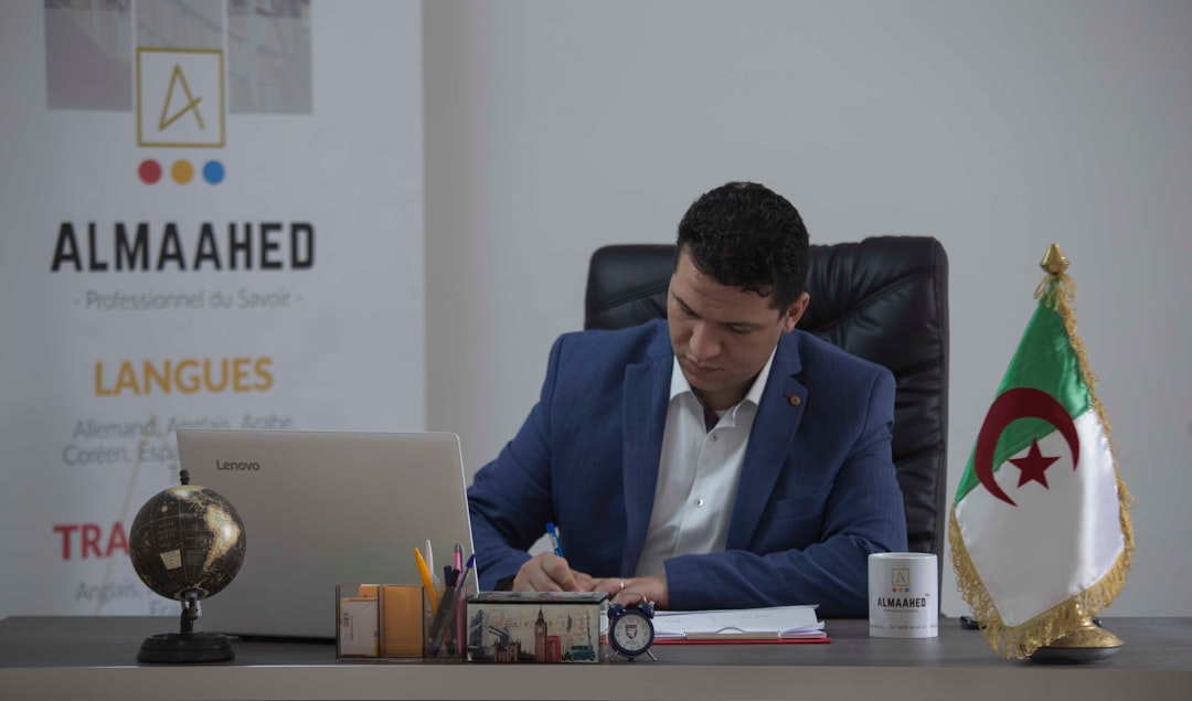 journey man-in-blue-suit-jacket-sitting-on-black-office-rolling-chair-ealtuum7dzm